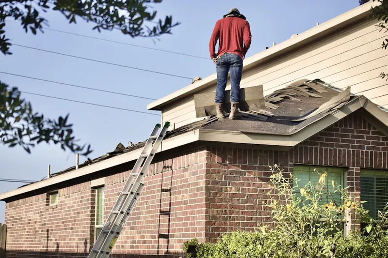 Professional roofer working on a residential roof in La Porte